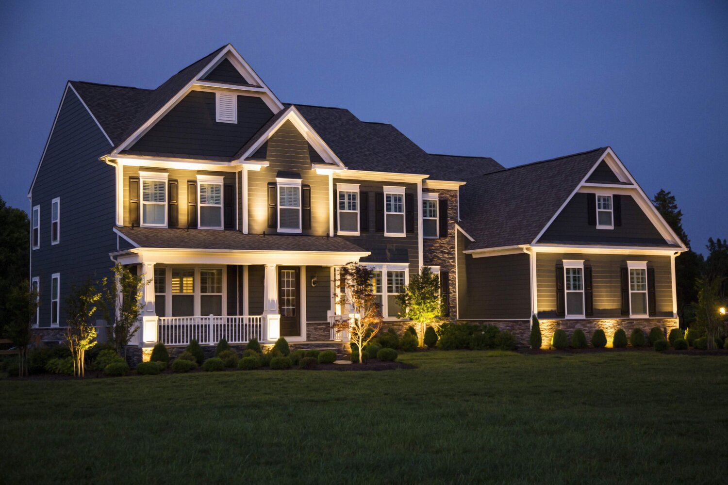 a home with landscape lighting