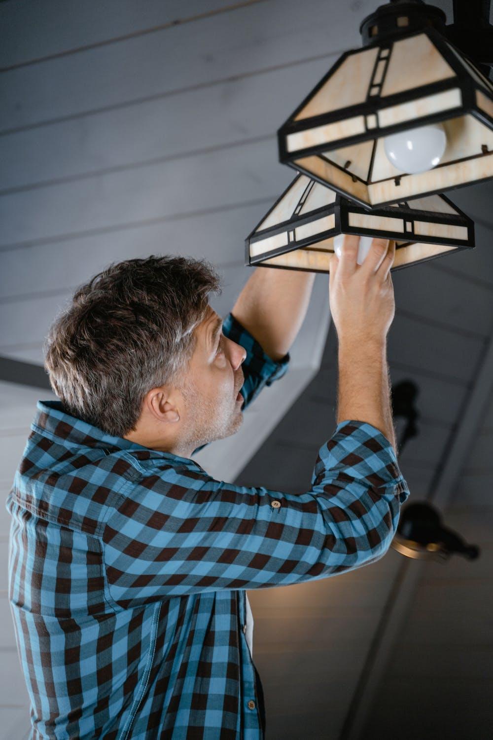 An image of a man fixing a light