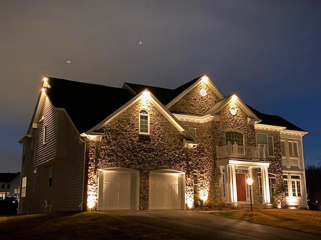 An image of a house with landscape lighting