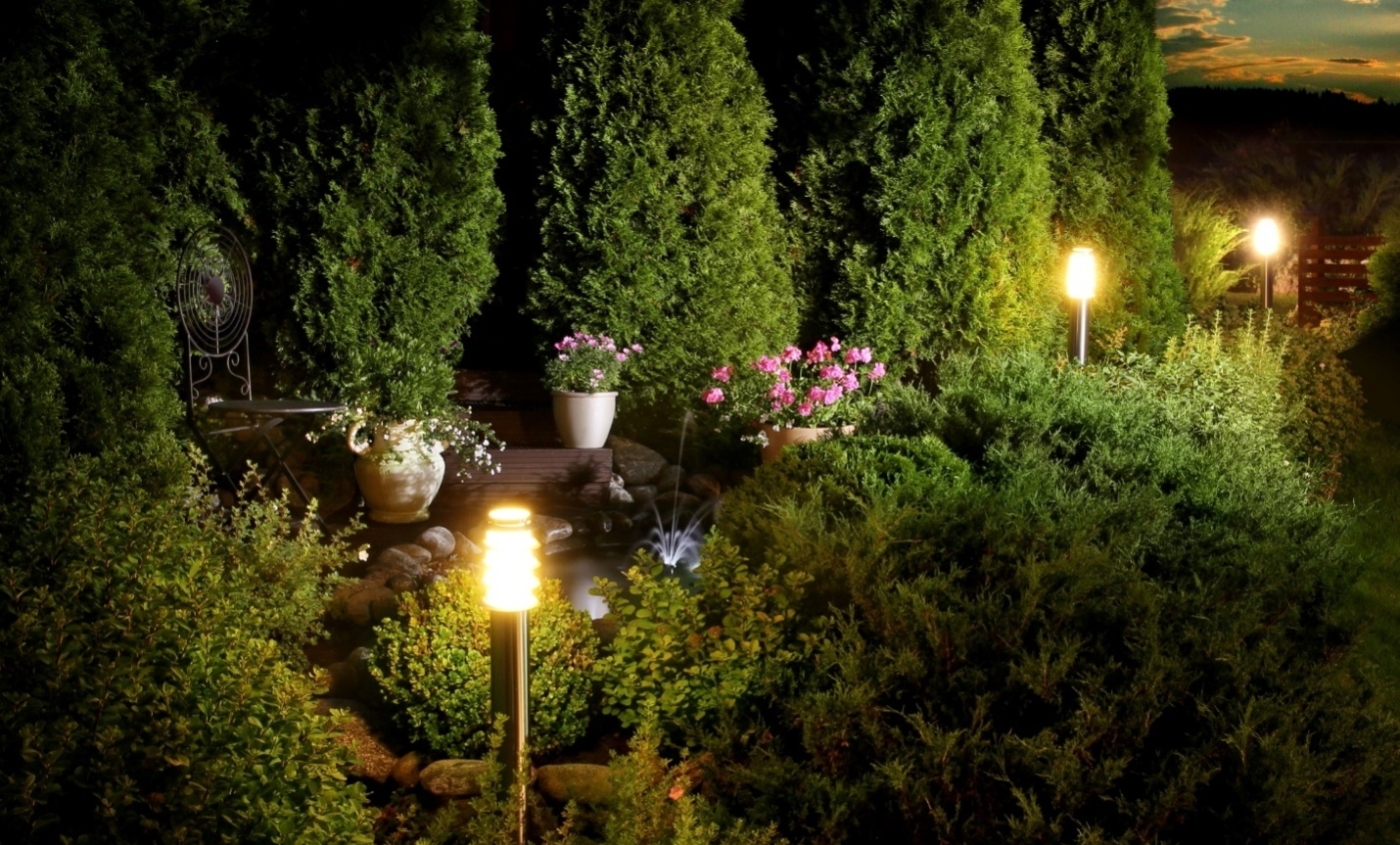 Outdoor lights turned on at night.
