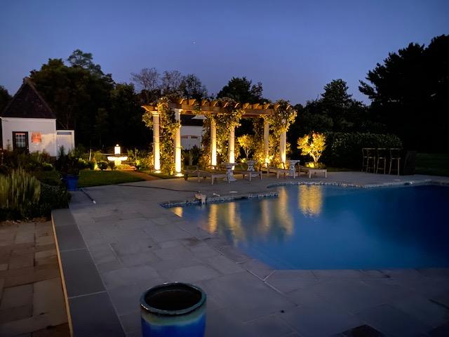 Beautiful outdoor lighting near a pool area.