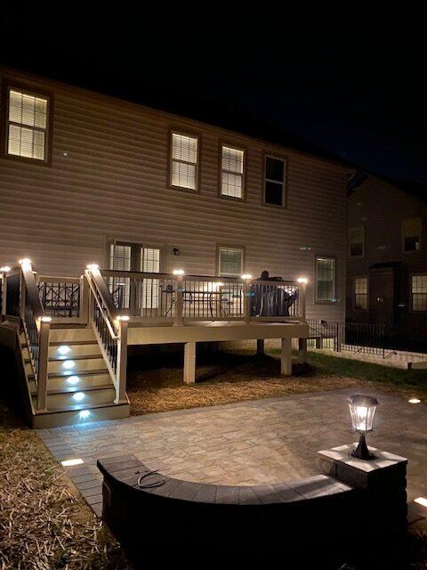 A well-lit home patio with curb lighting highlighting its architectural