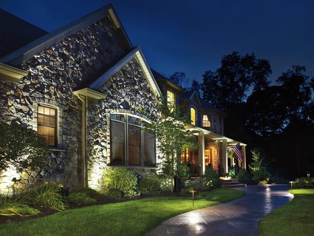 A beautifully illuminated outdoor space at night featuring a pathway and architectural lighting.