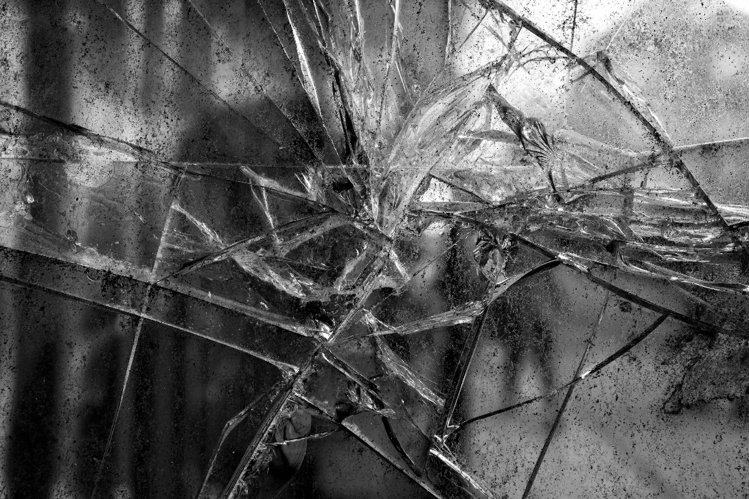 Broken window glass showing a house left vulnerable at night without outdoor lighting